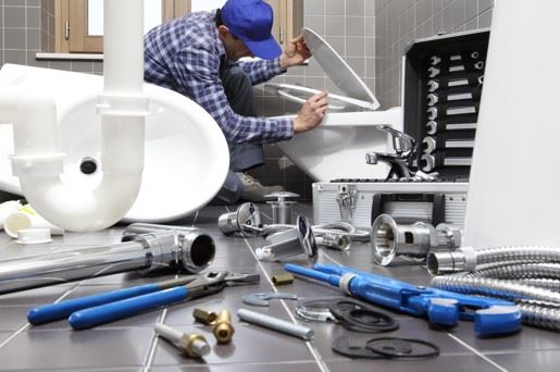 plumber installing a toilet